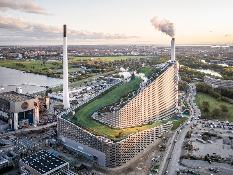 CopenHill or Amager Bakke waste-to-energy facility in summer with its green hiking trail and view to the city.