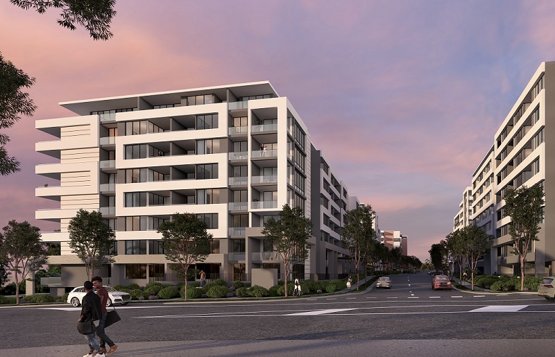 The proposed Tallawong Road development with its multiple eight storey buildings along a tree-lined road next to the train station at sunset.